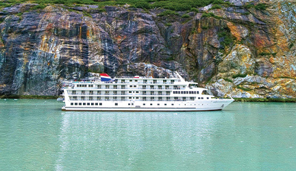 A group of tourists admire the beautiful Alaskan mountain landscape.