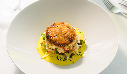 A white plate with Dungeness Crab served on American Cruise Lines Puget Sound & San Juan Islands itinerary