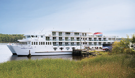 The new American Eagle cruise ship docked at a port.