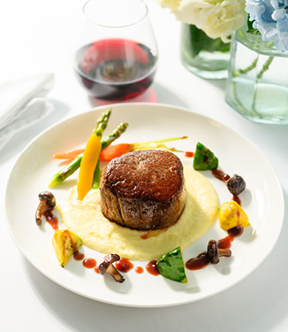Seared Filet of Beef served with creamy Potato Puree, Foraged Columbia River Mushrooms, Baby Carrots, Pati Pan Squash, topped with a Marionberry Demi-Glace Sauce served on American Cruise Lines.