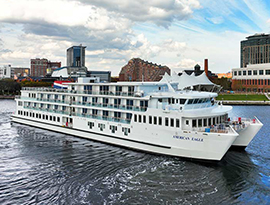 American Eagle Coastal Cat sailing along Chesapeake Bay, with the city of Baltimore in the distance.