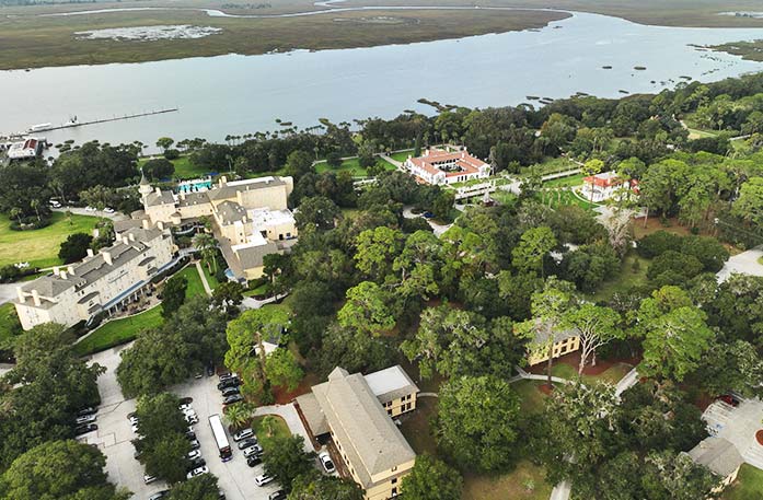 A birds-eye-view of Jekyll Island's large mansions, abundant trees, and a glimpse of the Intracoastal Waterway. 