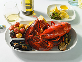 Boiled lobster dinner Native Maine Lobster Chatham Little neck Clams & Blue Mussels, Salt Boiled New Potatoes, Milk & Honey Boiled Corn, and Drawn Cabot Butter served on American Cruise Lines