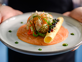 Smoked salmon appetizer with Columbia River Smoked Sockey Salmon, Pickled Fennel, Carrot & Bean Slaw, Huckleberry Caviar Crepe, served on American Cruise Lines.