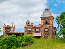 Olana State Historic Site, a historic house museum in Catskill with distinct yellow, blue, and red patterns alongside the building, and red and white striped window awnings.