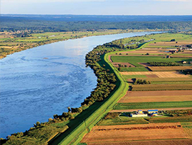 Aerial view of the winding  Ohio River surrounded by expansive farmland and greenery.