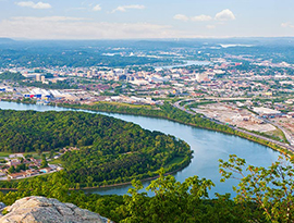 Aerial view of the Mississippi River with sights of a large city in the distance.