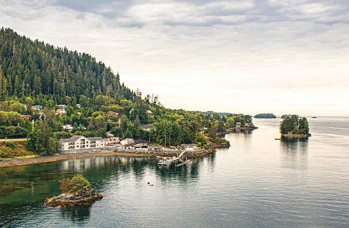 Aerial view of the town and forests of Sitka alongside the waters of the Inside Passage.