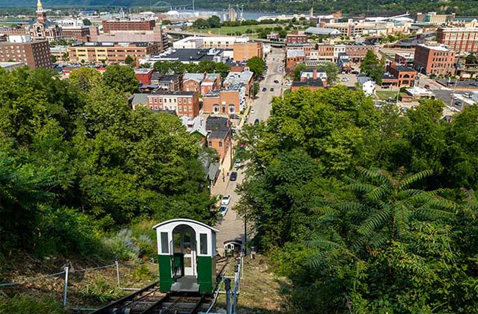 An aerial view of buildings from the top of Fenelon Place Elevator in Dubuque, where green and white cars travel the historic cable railway.